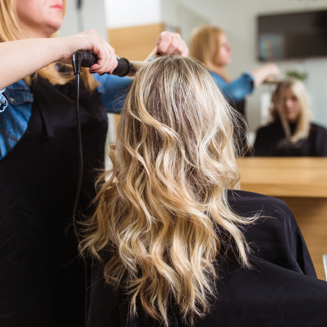 Stylist creating soft blonde waves